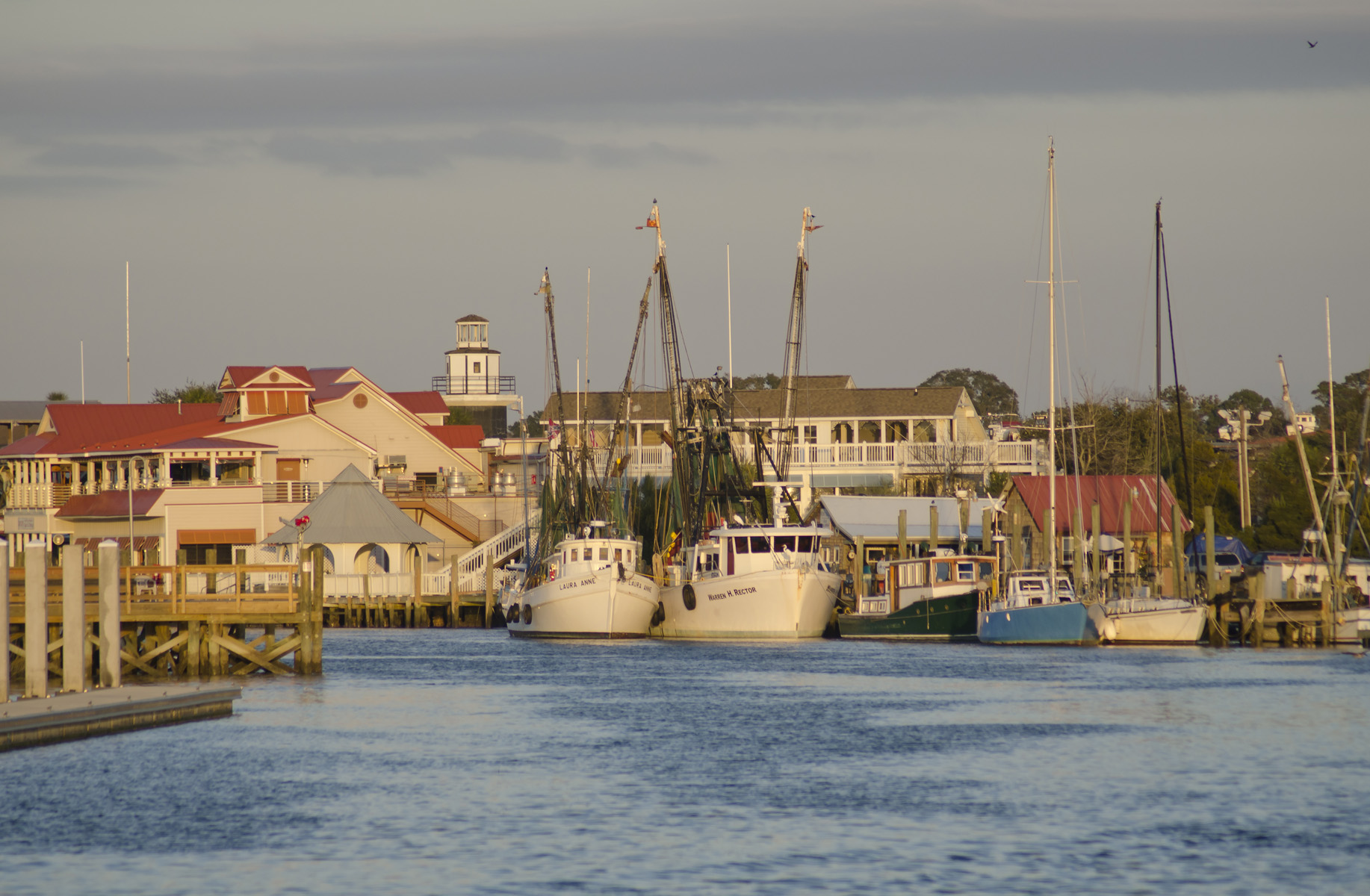 Shrimp boats moored along Shem Creek at dusk in Mount Pleasant, South Carolina.